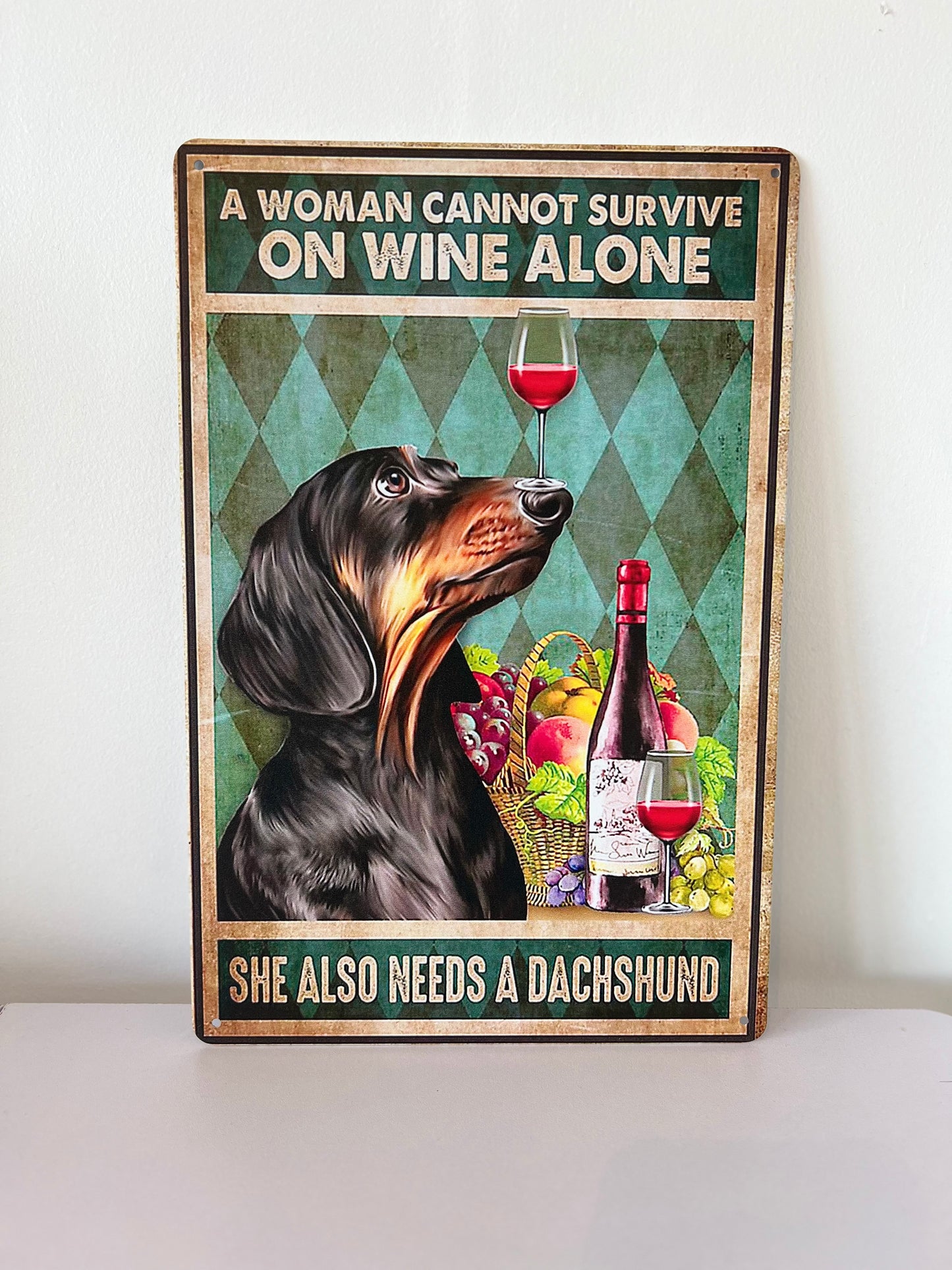 A woman cannot survive on wine alone metal sign.